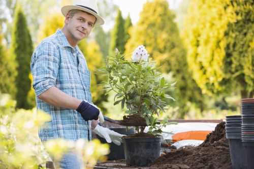 Gardener wearing protective equipment while using powered tools